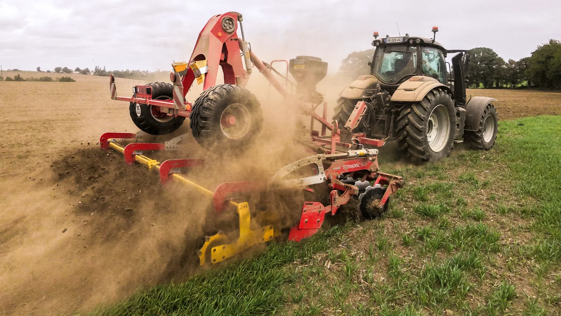 A tractor tilling the land in an industrial mono-crop farm