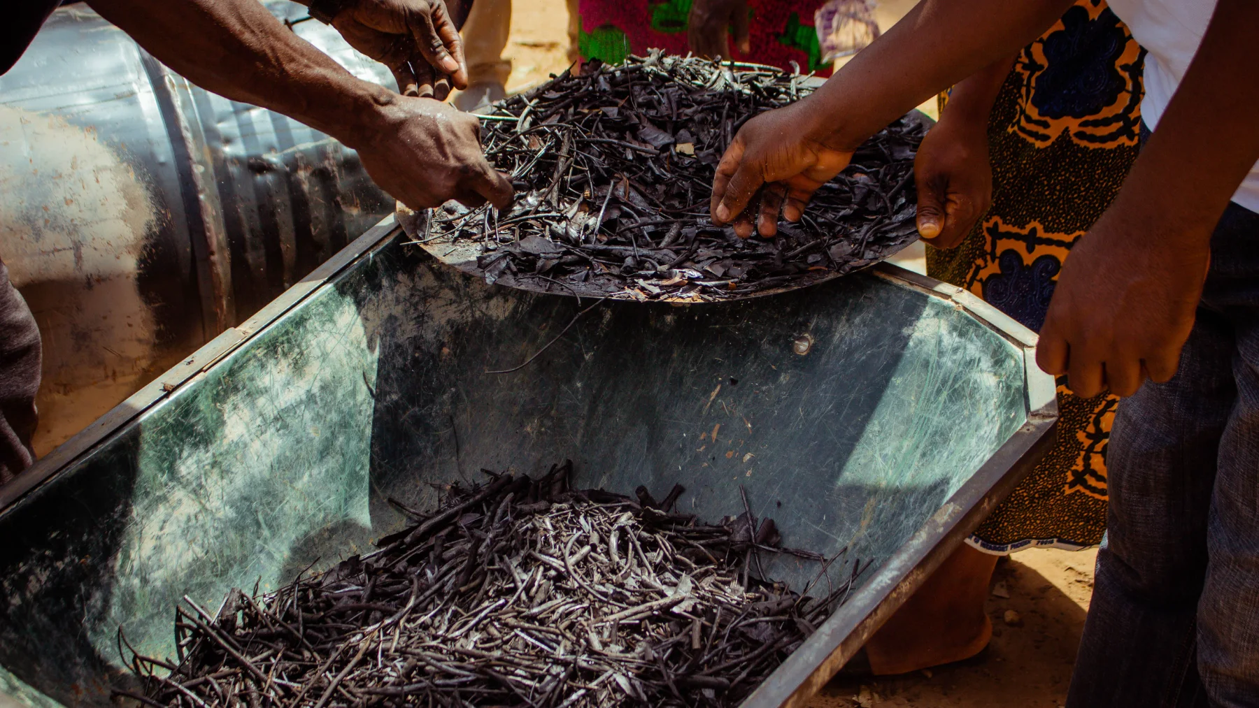 A group of Kenyan farmers sorting out residue to be used in biochar production