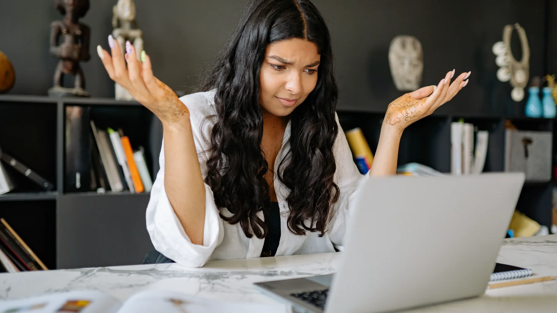 A person lifting their hands up in frustration for failure to understand information on a climate tech's website page